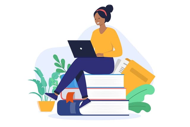 A person sitting cross legged on top of a stack of books with a laptop in their lap.