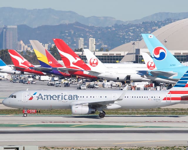 Planes taxiing on the runway and parked at the gates at Los Angeles International Airport. 