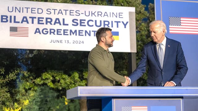 President Zelenskyy of Ukraine and President Biden of the United States shake hands.