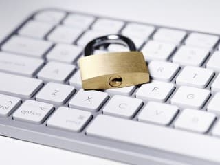 A padlock lying on a computer keyboard